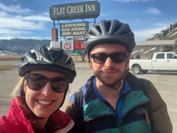 Biking in front of the Flat Creek sign.